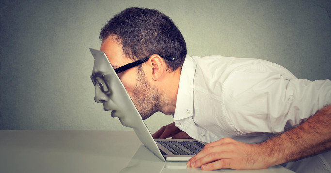 man watching through his macbook becoming a machine